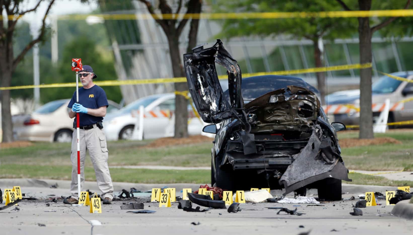 FBI crime scene investigators documented evidence outside the Curtis Culwell Center in...