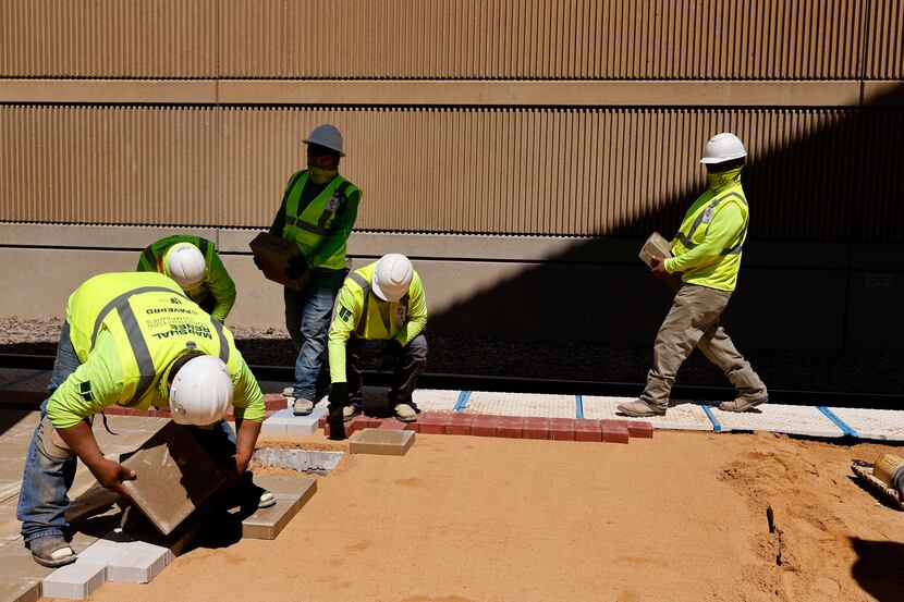 Construction workers remake the platform at DART's Mockingbird Station during U.S....