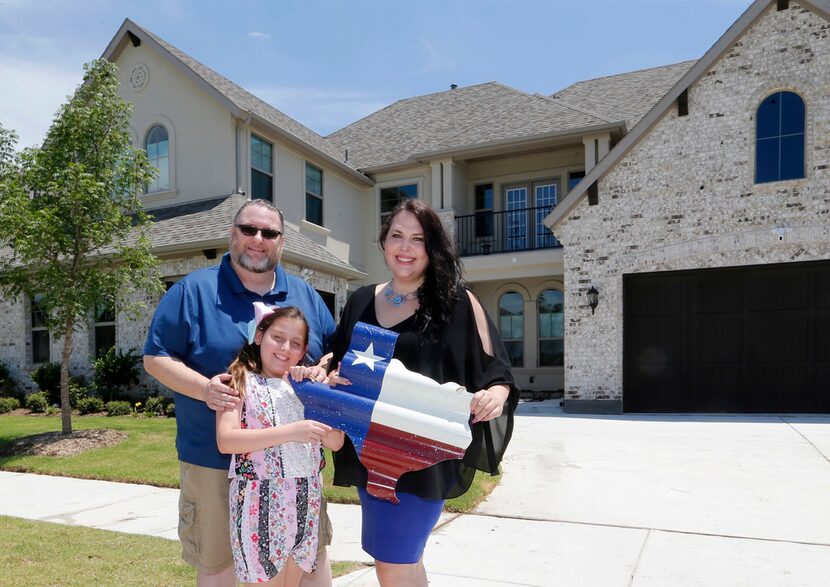 Scott and Marie Bailey, with their daughter Alexandra, in front of their home at Windsong...