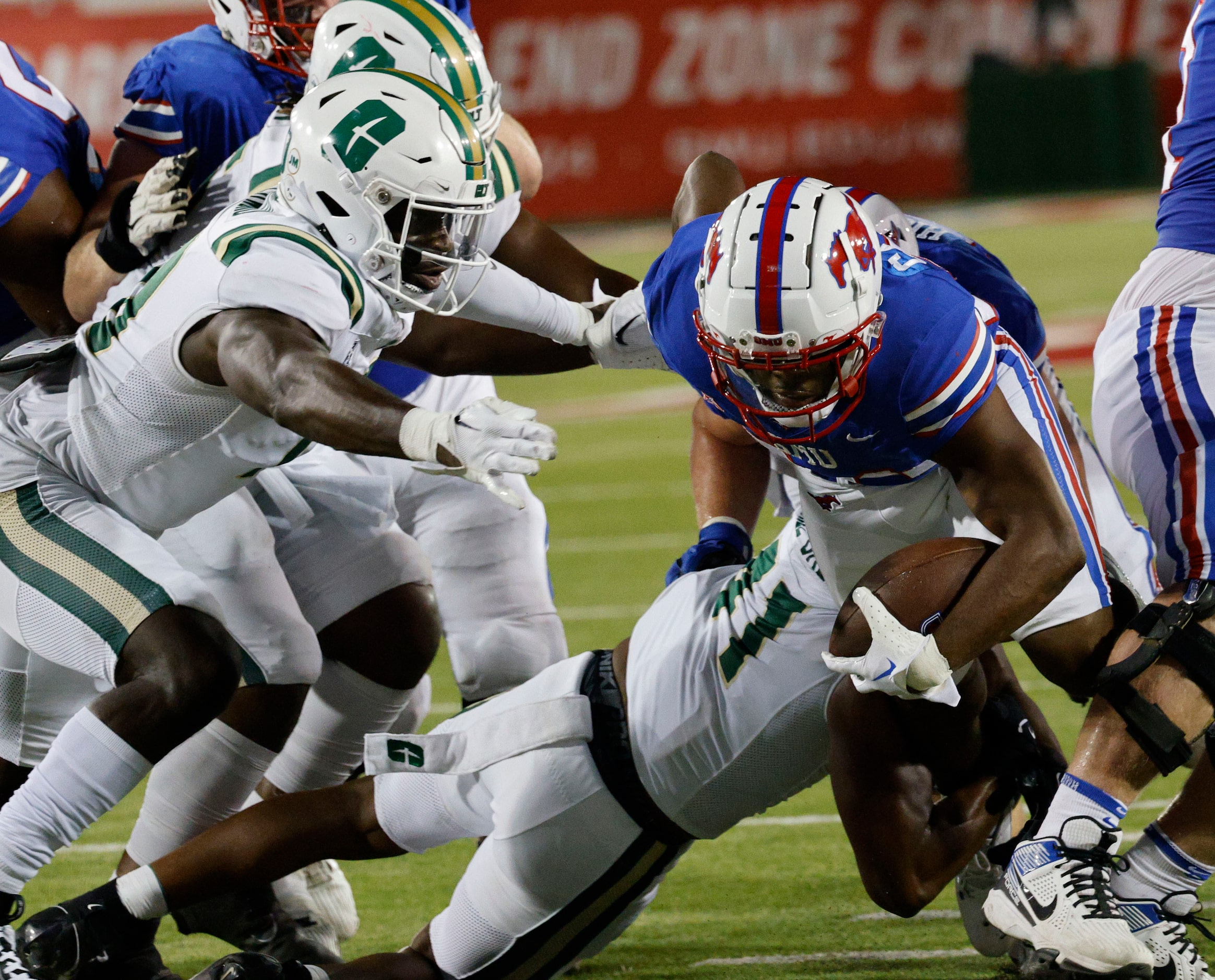 SMU running back Velton Gardner (24) is tackled by Charlotte 49ers linebacker Stone Handy...