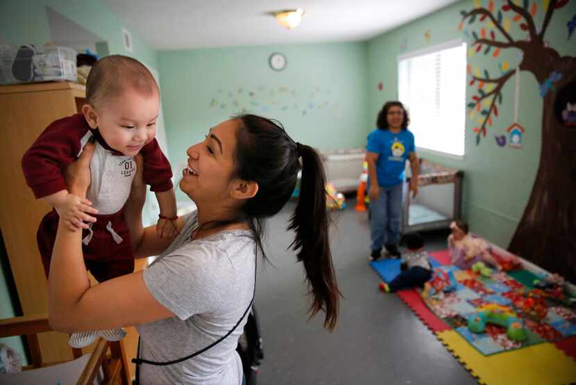 Amber Bolanos plays with her son Julius after changing his diaper in the nursery at Santa...