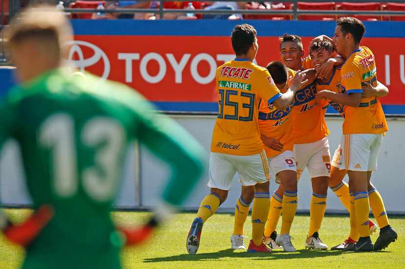 Tigres UANL team members mob Jesus Garza after he scored a goal late in the second half...