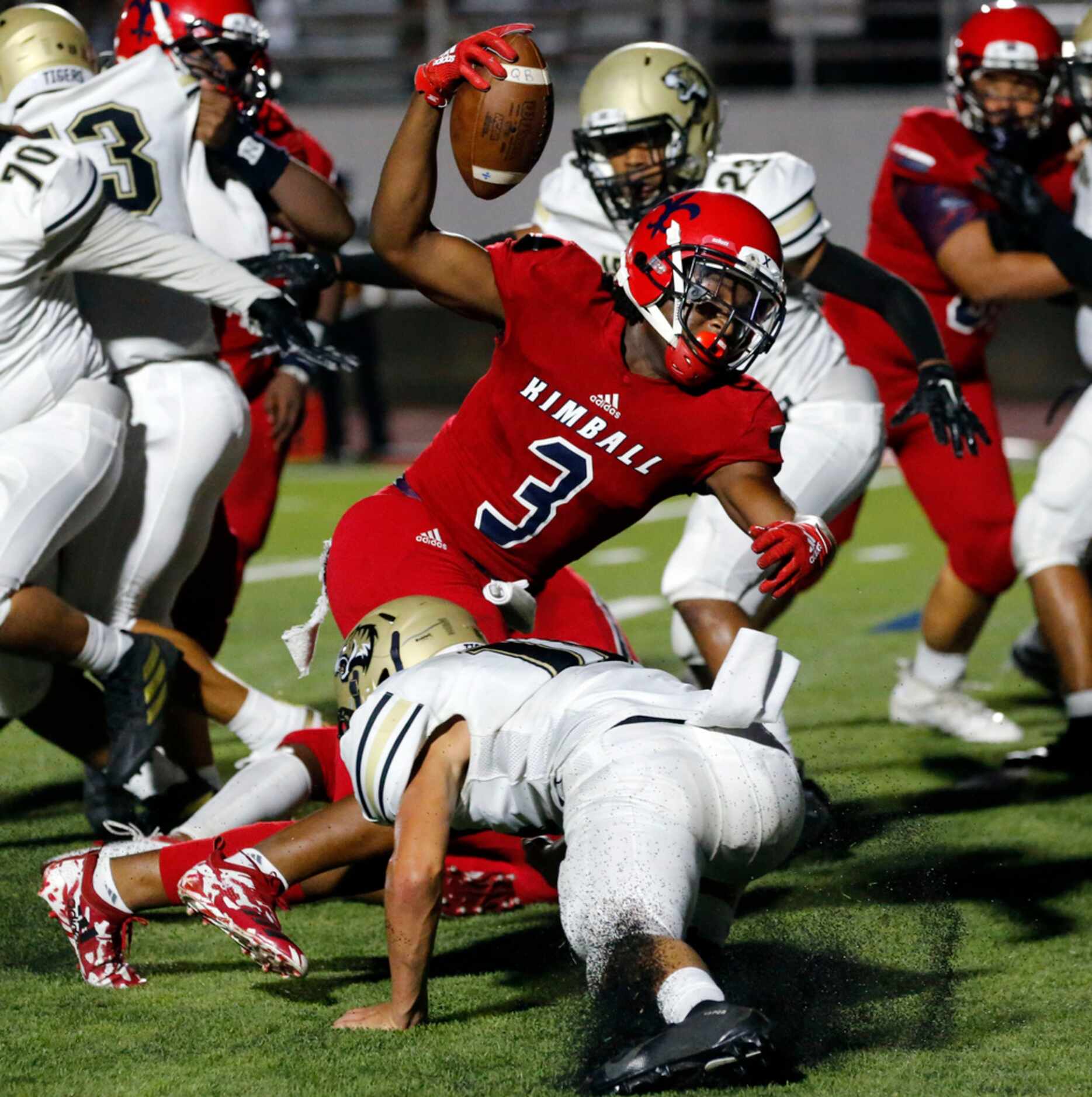 Kimball High RB Cortavious Smith (3) holds the ball high, as he rushes into the end zone for...