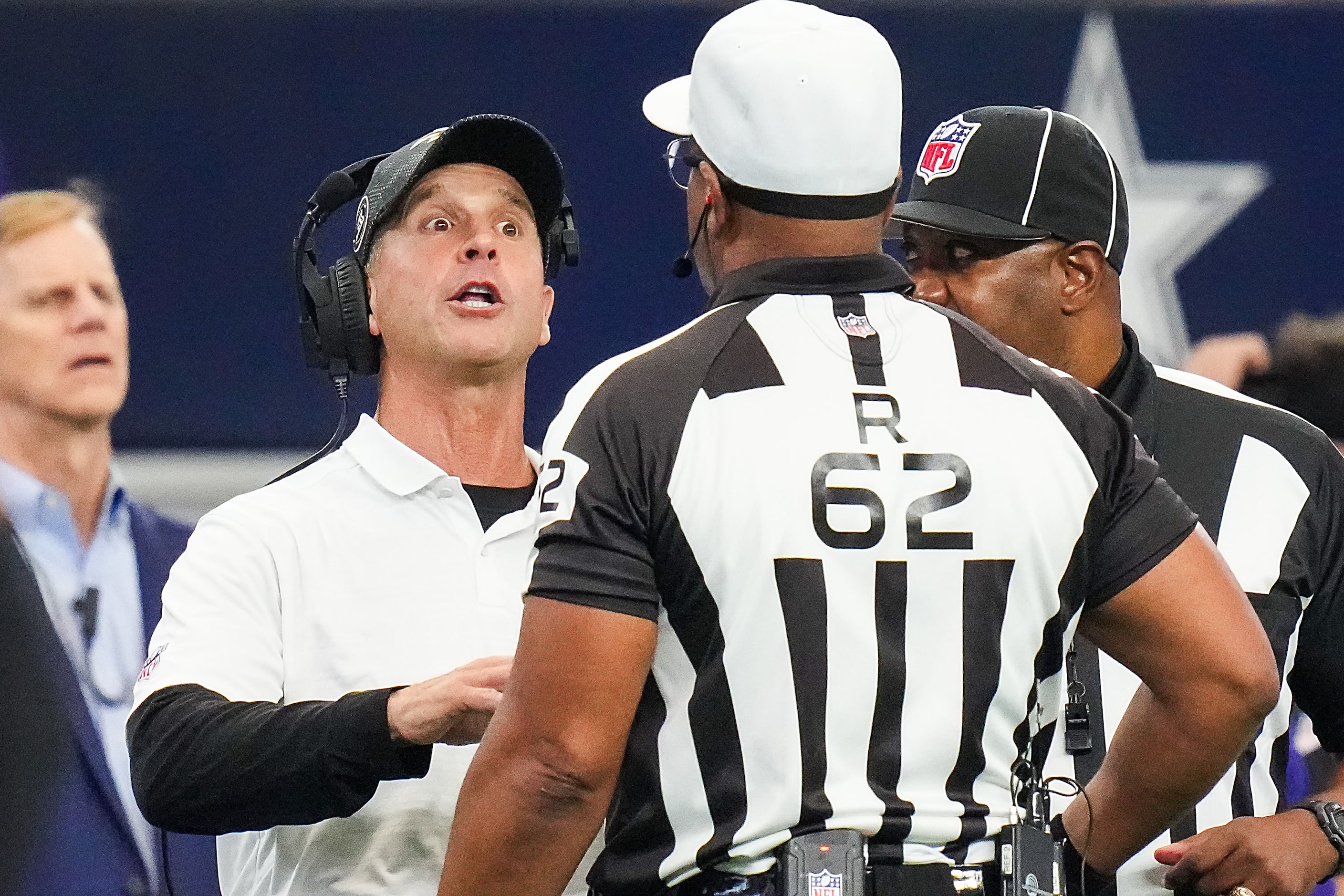 Baltimore Ravens head coach John Harbaugh talks with referee Ronald Torbert (62) during the...