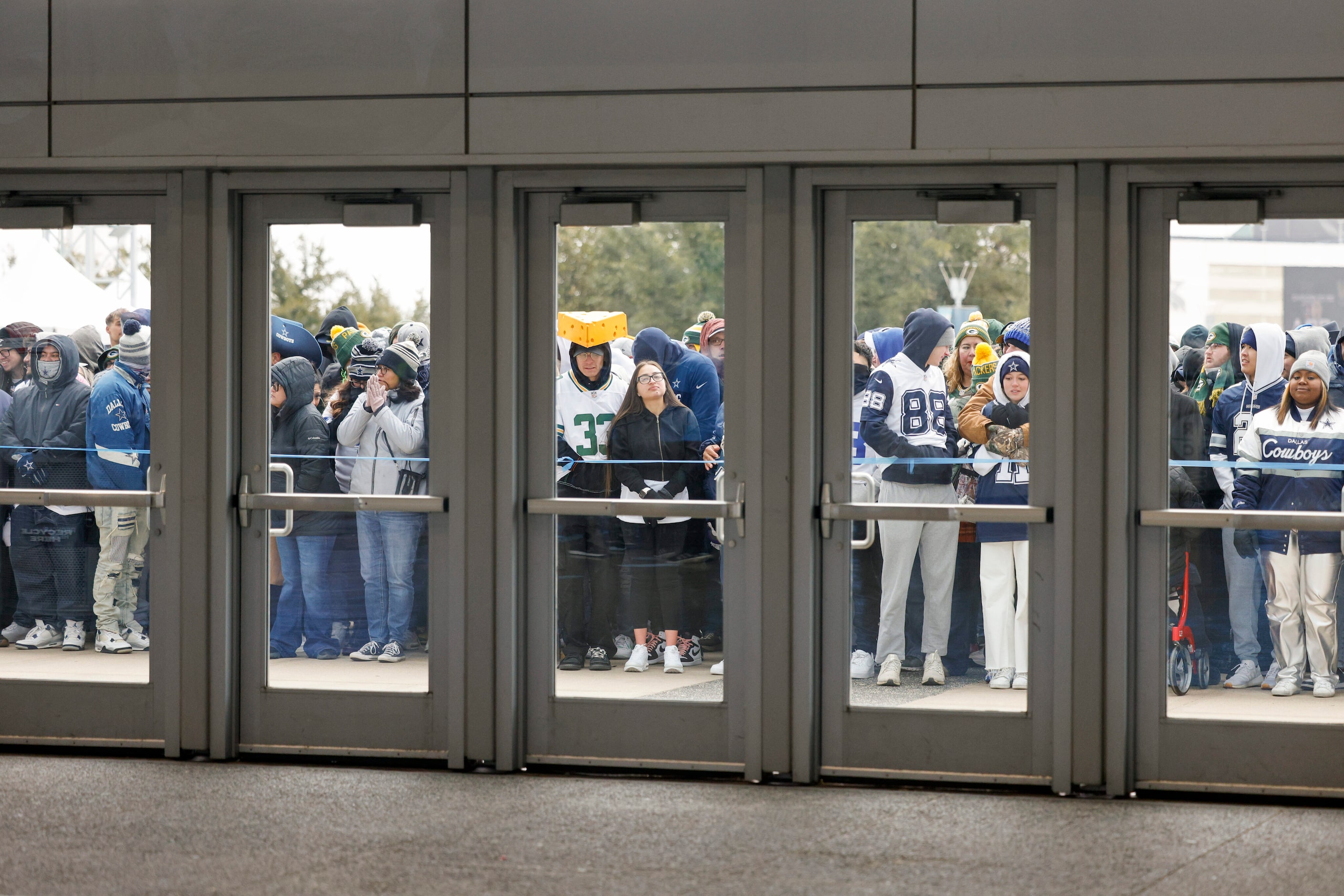 Fans wait for doors to open so they can claim their standing room only spots before an NFL...