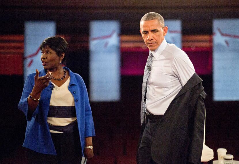 President Barack Obama removed his coat as he prepared to participate in a televised town...