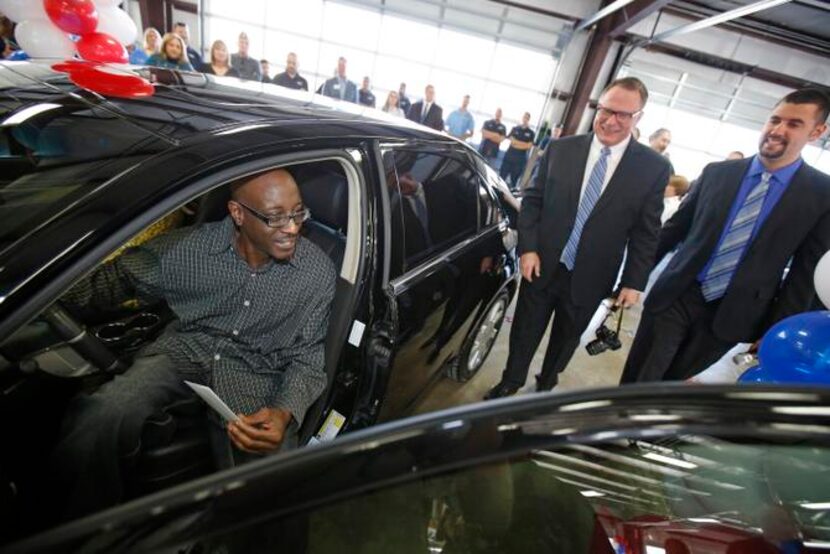 
Greg Clark (left), senior vice president of marketing at Caliber Collision, and Tom Burch,...