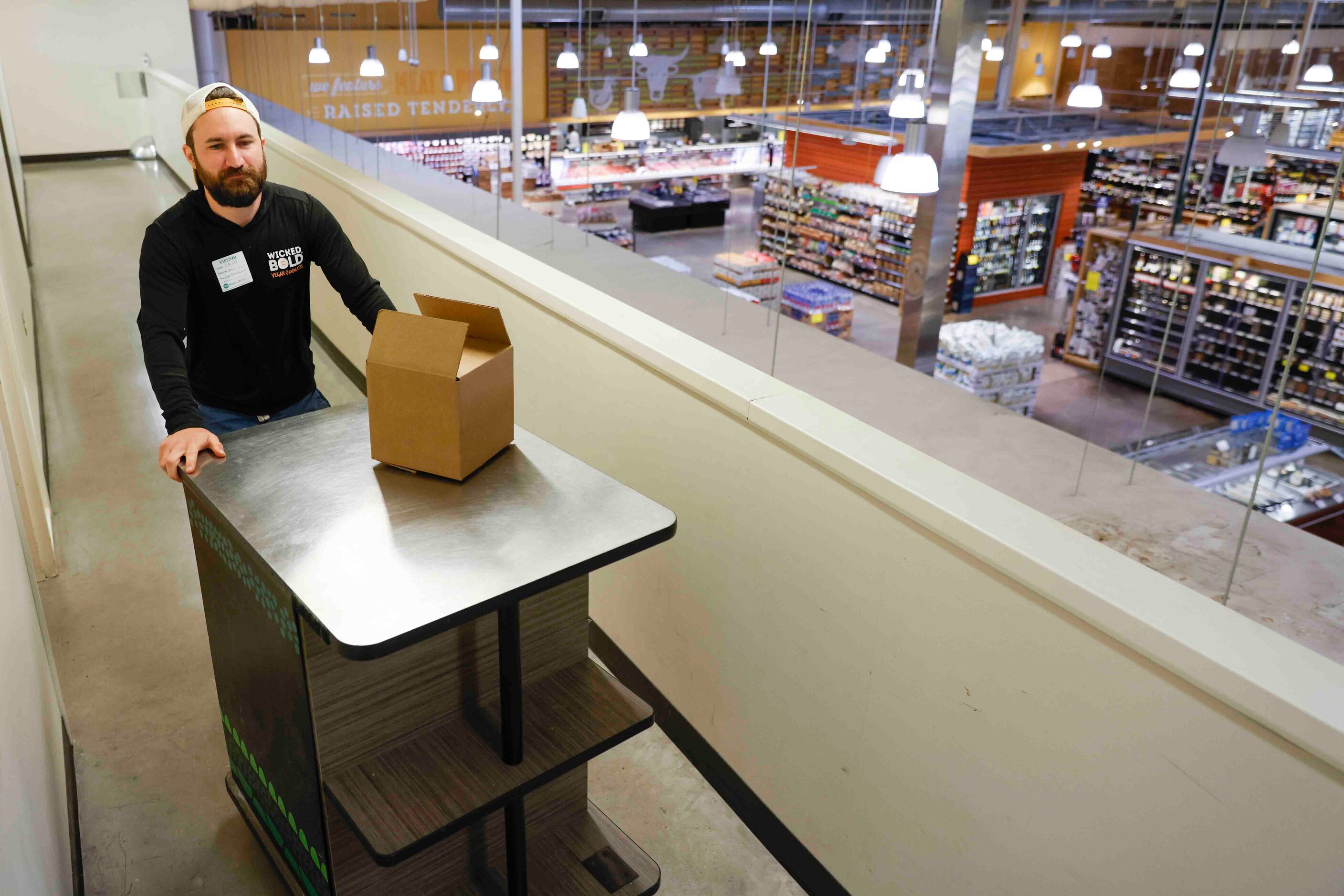 Deric Cahill pushes a rolling table from a storage room on the second floor of the Whole...