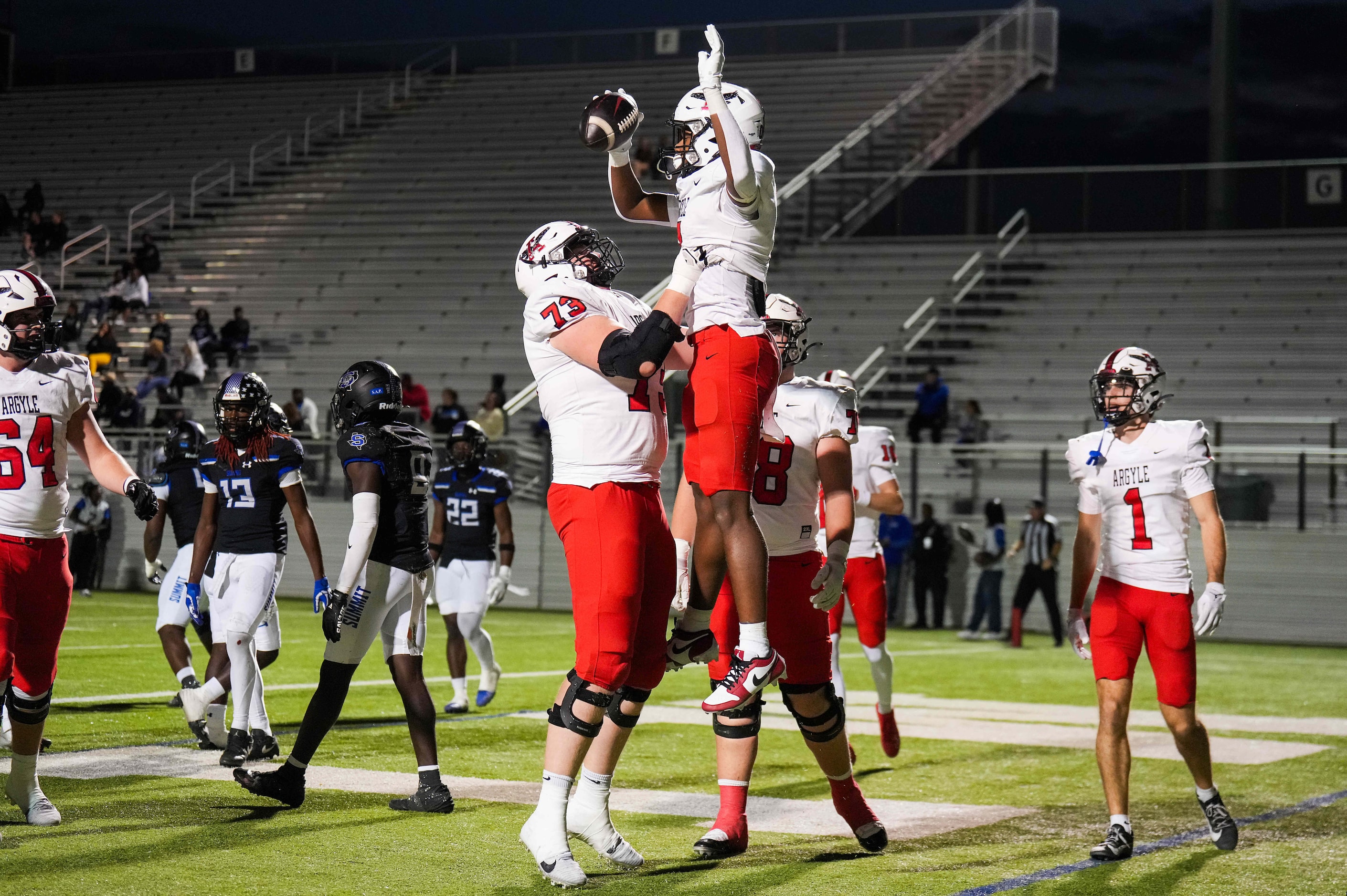 Argyle running back Chase Bagley (0) celebrates a touchdown with offensive lineman Tyler...