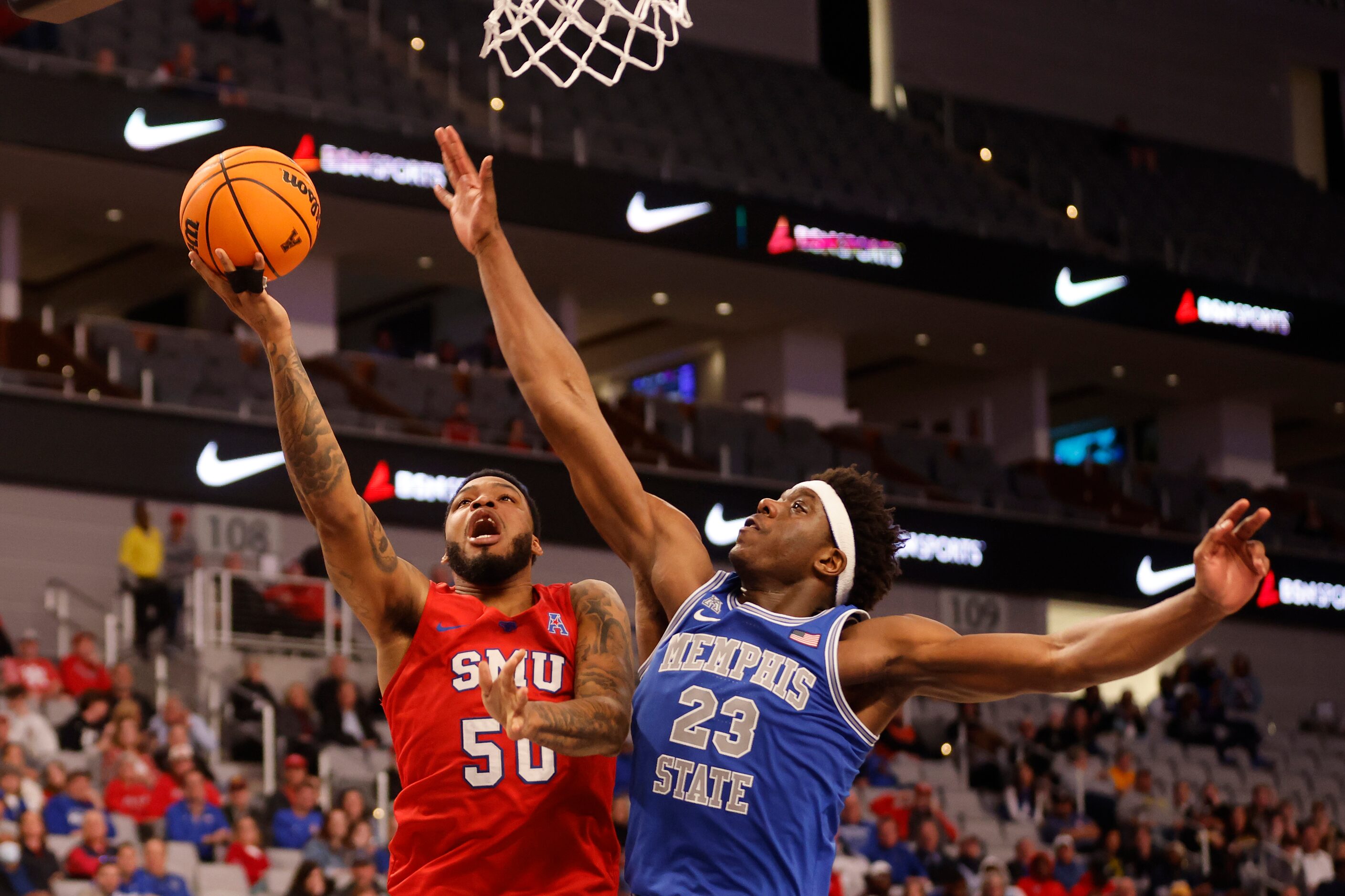 SMU forward Marcus Weathers (50) shoots against Memphis center Malcolm Dandridge (23) during...