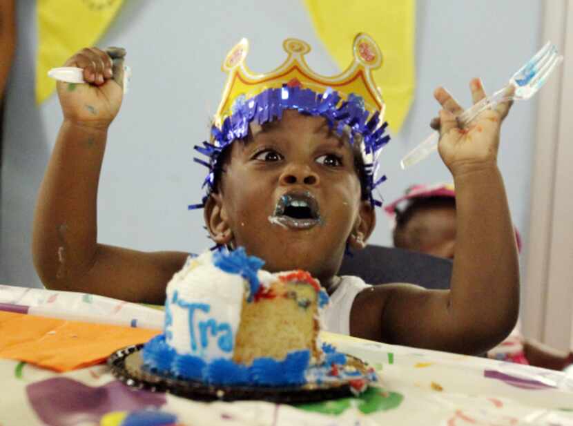Three-year-old De'Trayveon Reed enjoys his birthday cake at the monthly birthday party at...