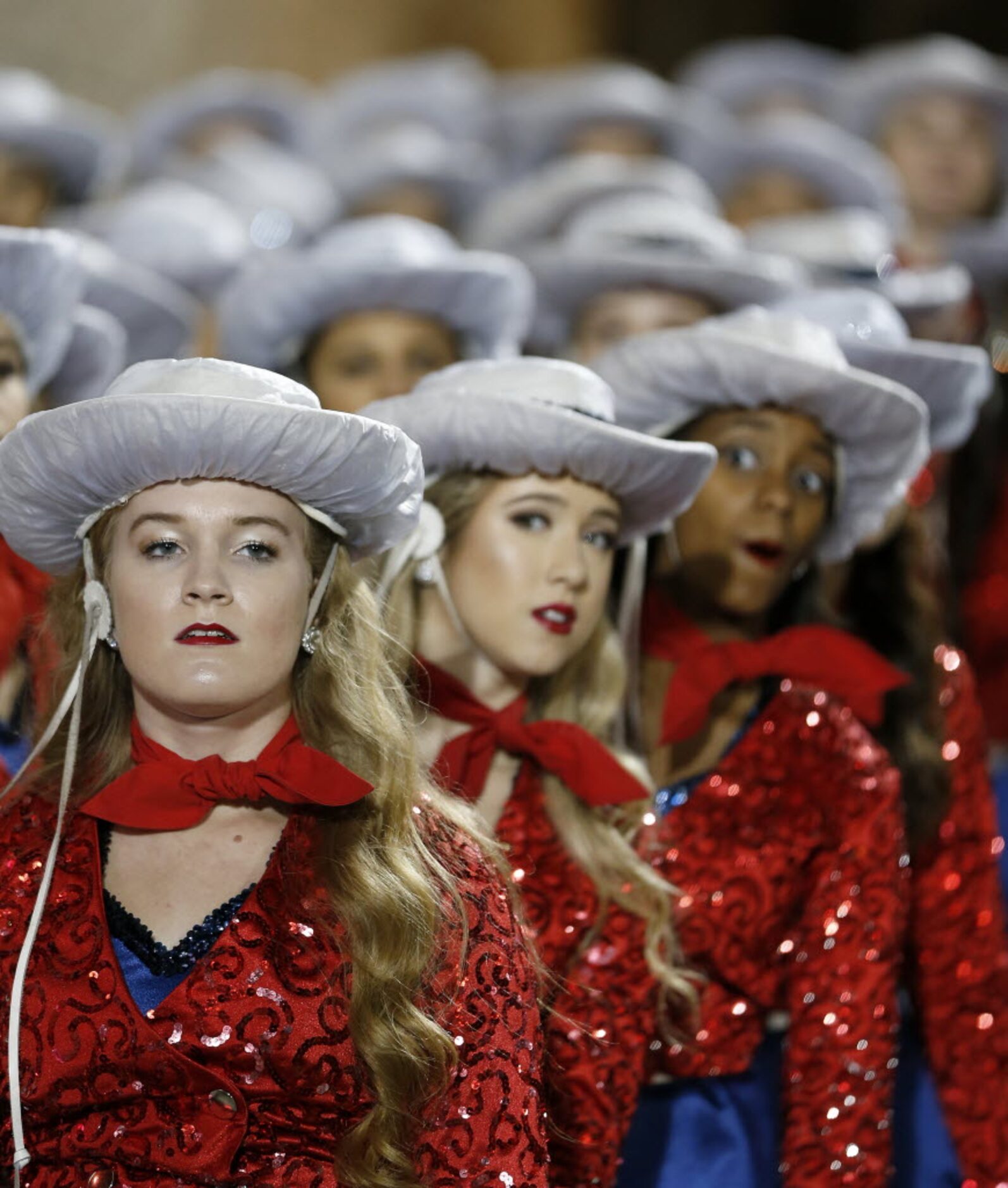 Members of the Allen High School's Tallenettes stand ready to perform during the first half...