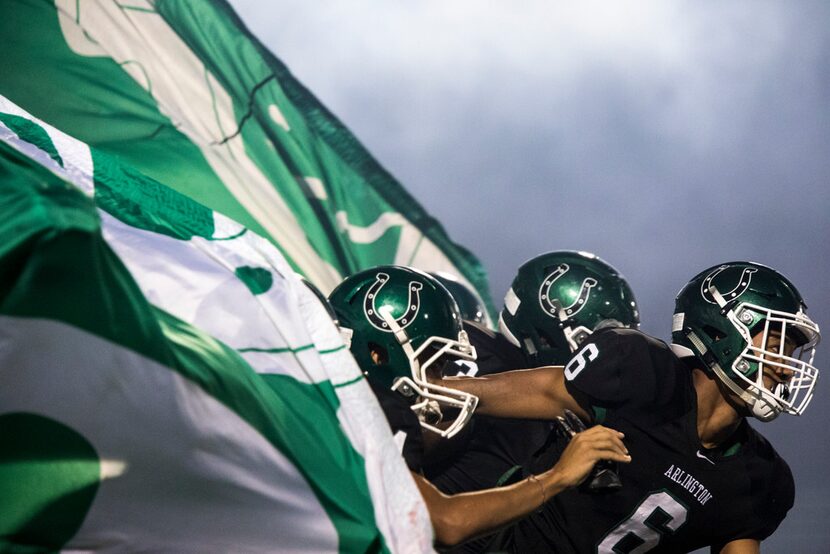 Arlington defensive back Xzavier Guyton (6) leads the Colts onto the field during a high...