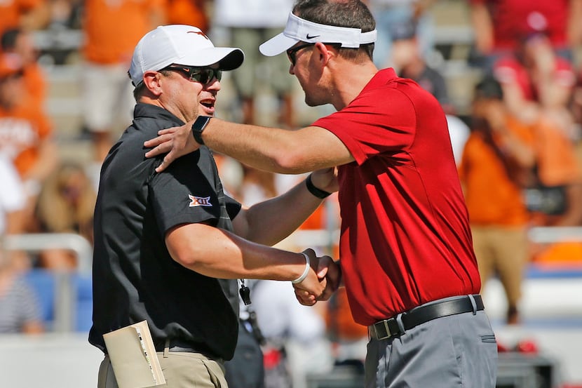 Longhorns coach Tom Herman, left, shakes hands with Sooners head coach Lincoln Riley before...