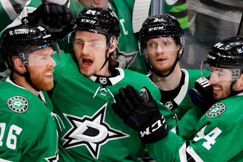 Dallas Stars center Roope Hintz (24) is congratulated on his first period goal by teammates...