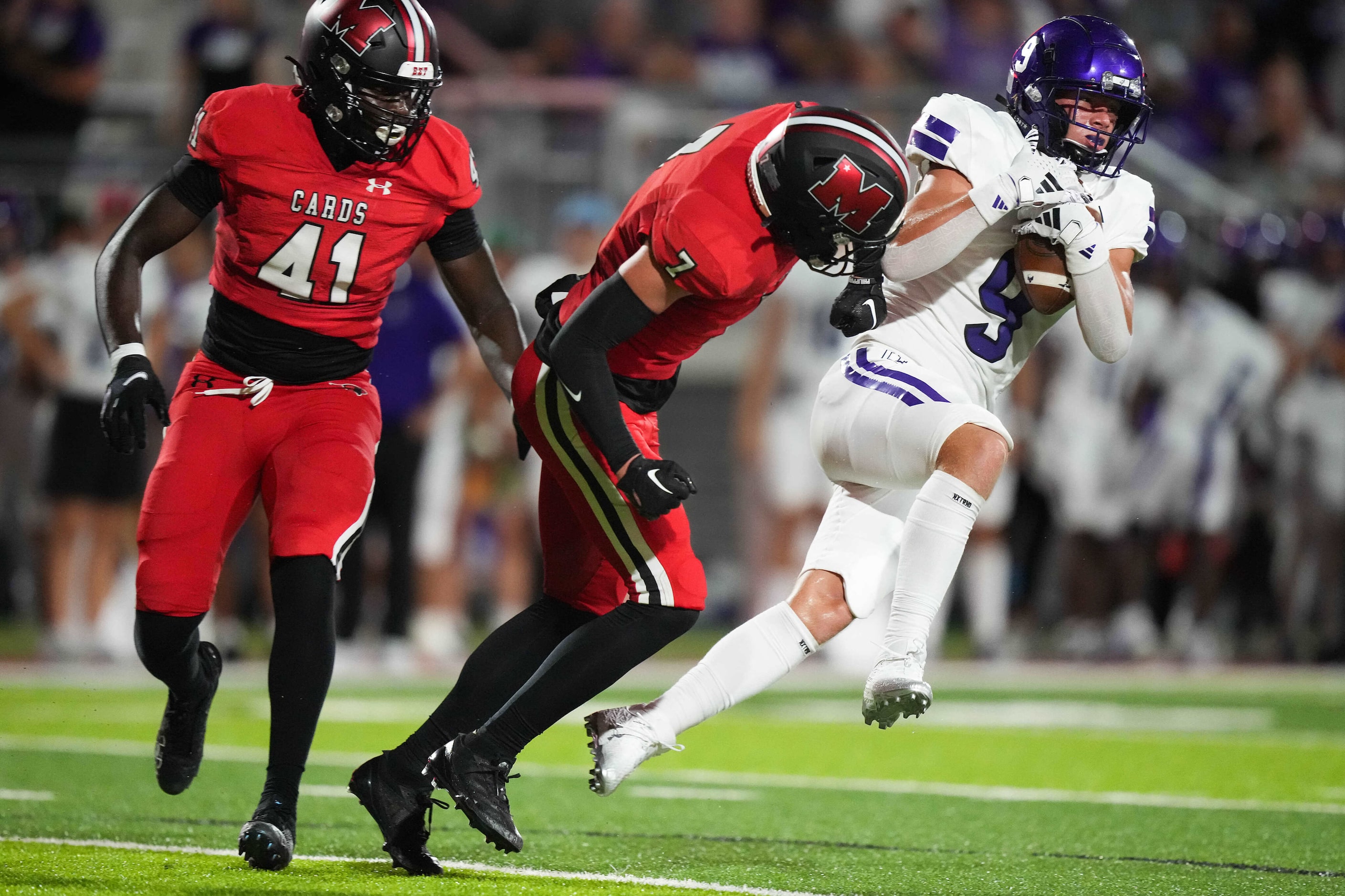 Anna wide receiver Roaen Nylander (9) is hit by Melissa defensive back Rocky Dunn (7) as he...