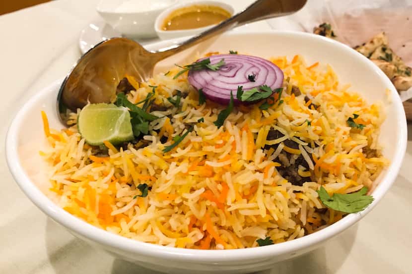 Goat biryani – an Indian layered rice dish – at Touch Nine in Irving. With explosive grown...