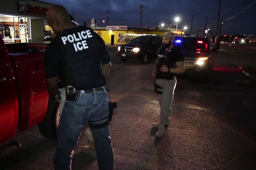 Federal immigration agents arrest a man April 1 in Dallas.