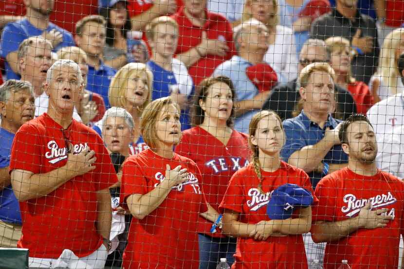Rangers fans sing "God Bless America" during Game 3 of the ALDS between the Texas Rangers...