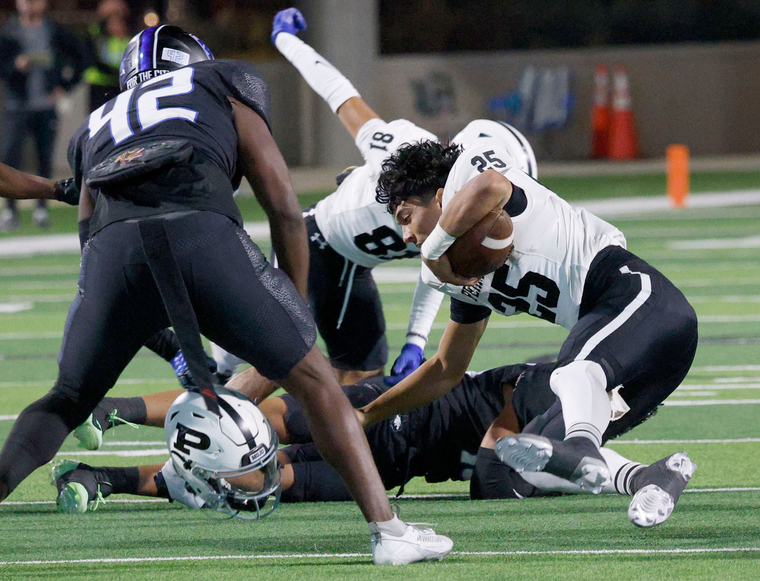 Permian's quarterback Jakob Garcia (25) loses his helmet by North Crowley's Neudre Cassey...