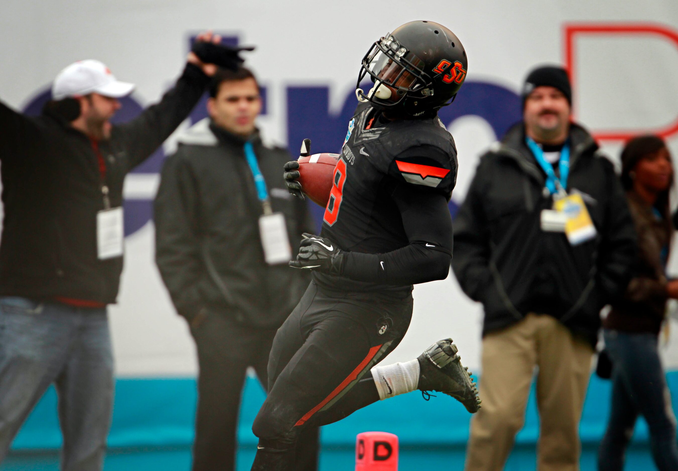 Oklahoma State Cowboys safety Daytawion Lowe (8) returns a fumble pass by the Purdue...