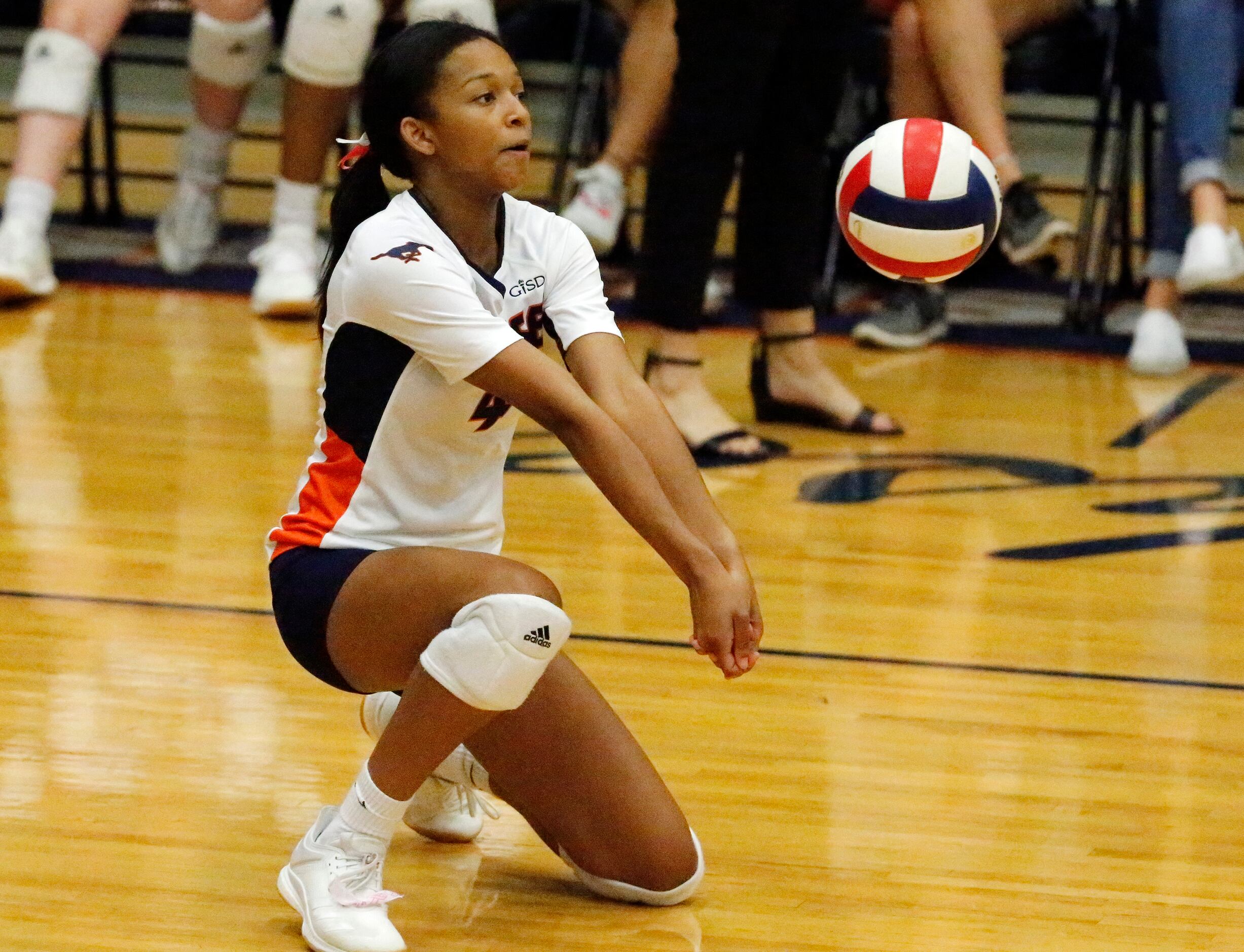 Sachse High School outside hitter Shaliyah Rhoden (4) fields a serve during game three as...