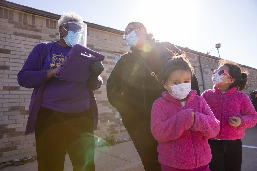 From left: Dr. Paula Morgan registered Norma Rodriguez for the vaccine Tuesday as her nieces...