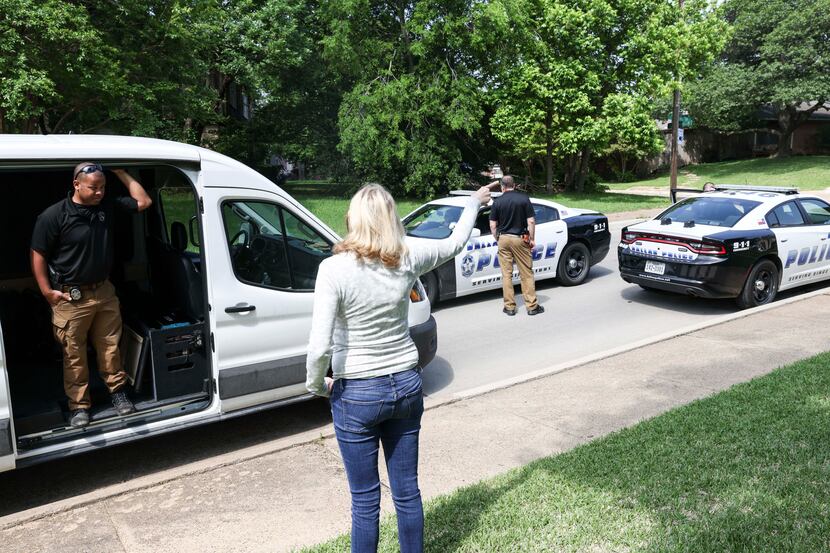 Resident Becky Withrow tells Dallas police officers where coyotes are seen in the mornings...