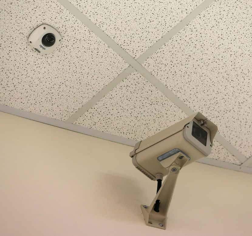 New camera on the ceiling next to one of the older models in a hallway at McKinney North...