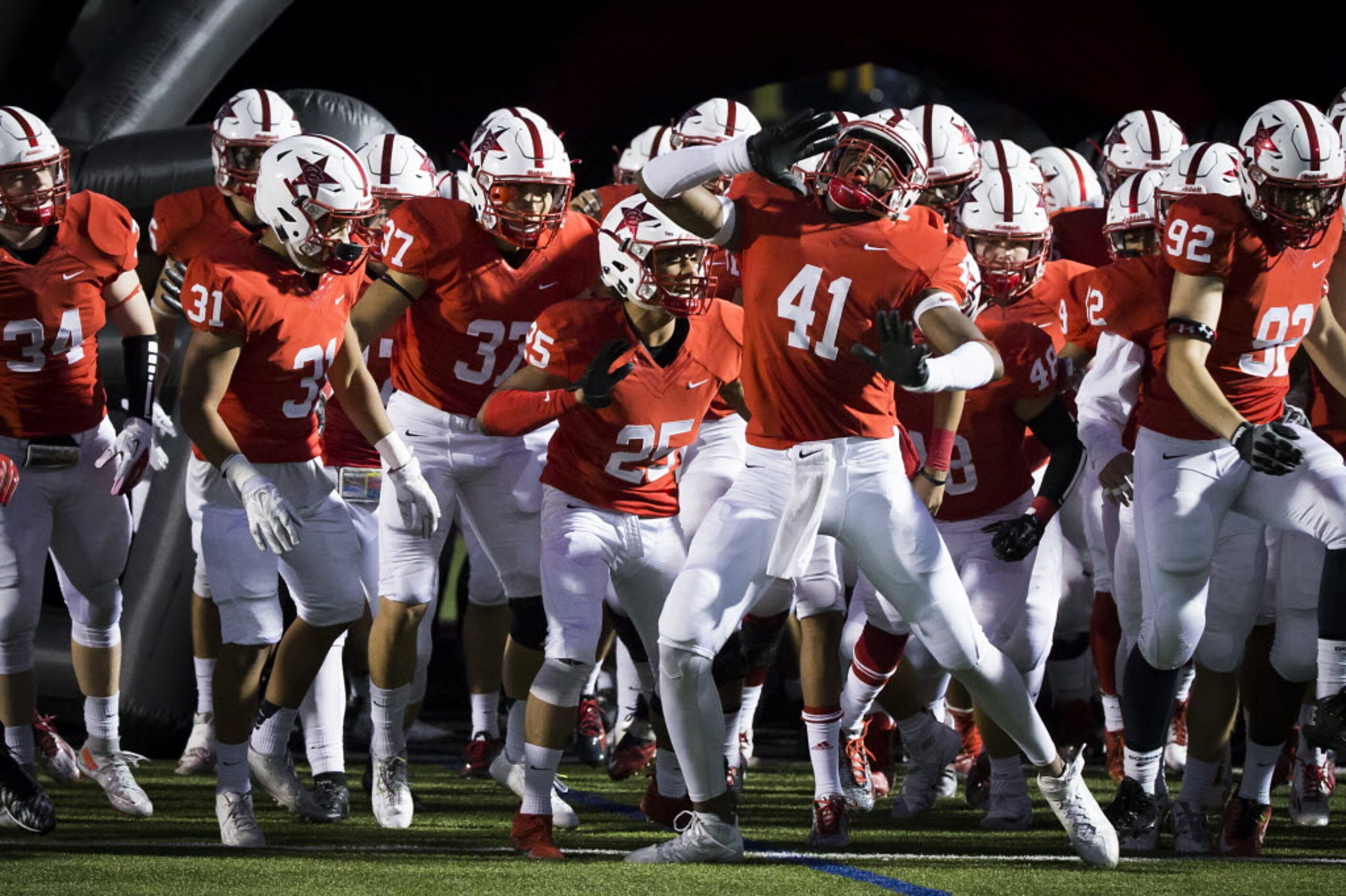 Coppell defensive lineman Solomon Wise (41) fires up his teammates before leading them on to...