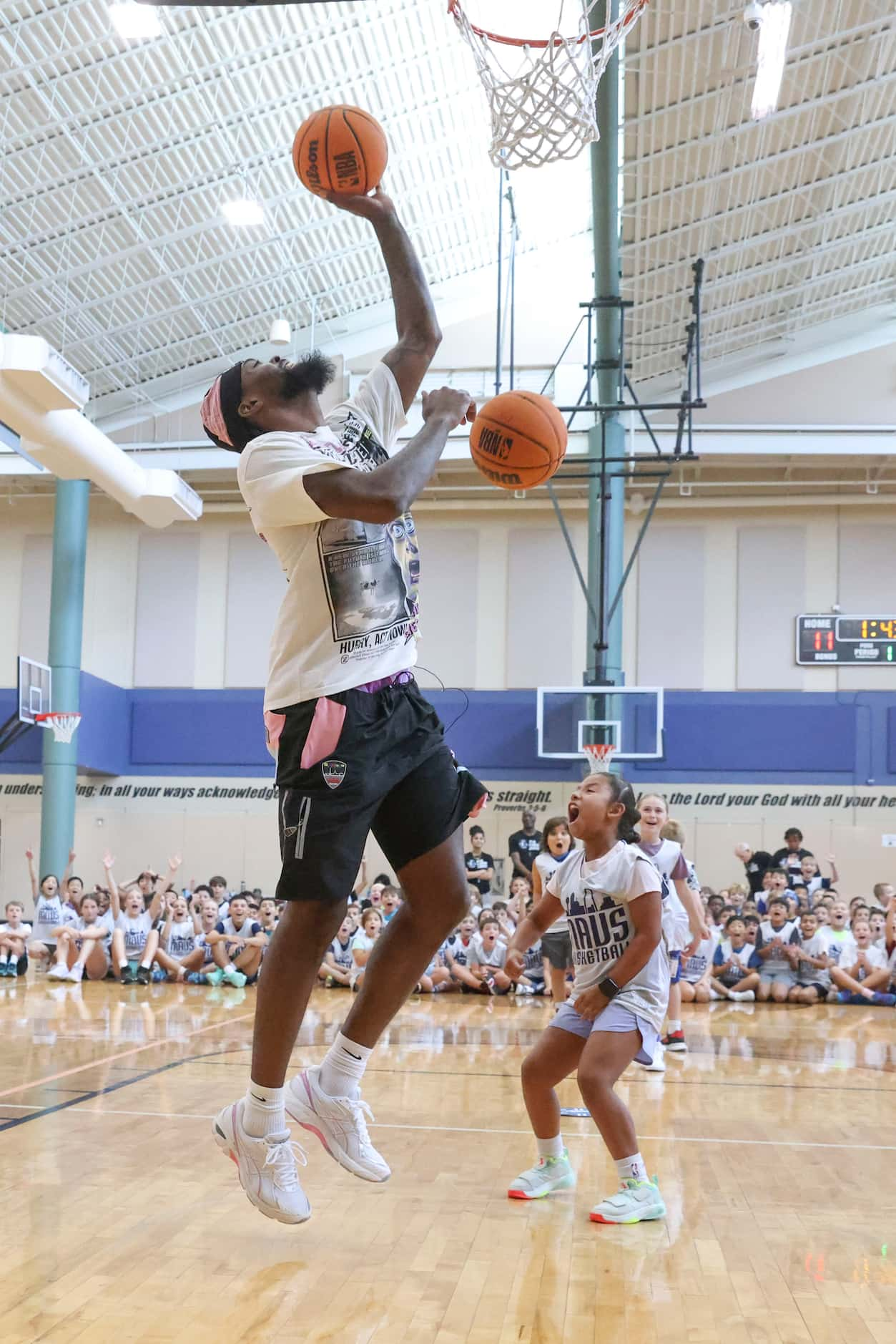 Dallas Mavericks’ Naji Marshall, competes against young basketball campers during a Hoop...