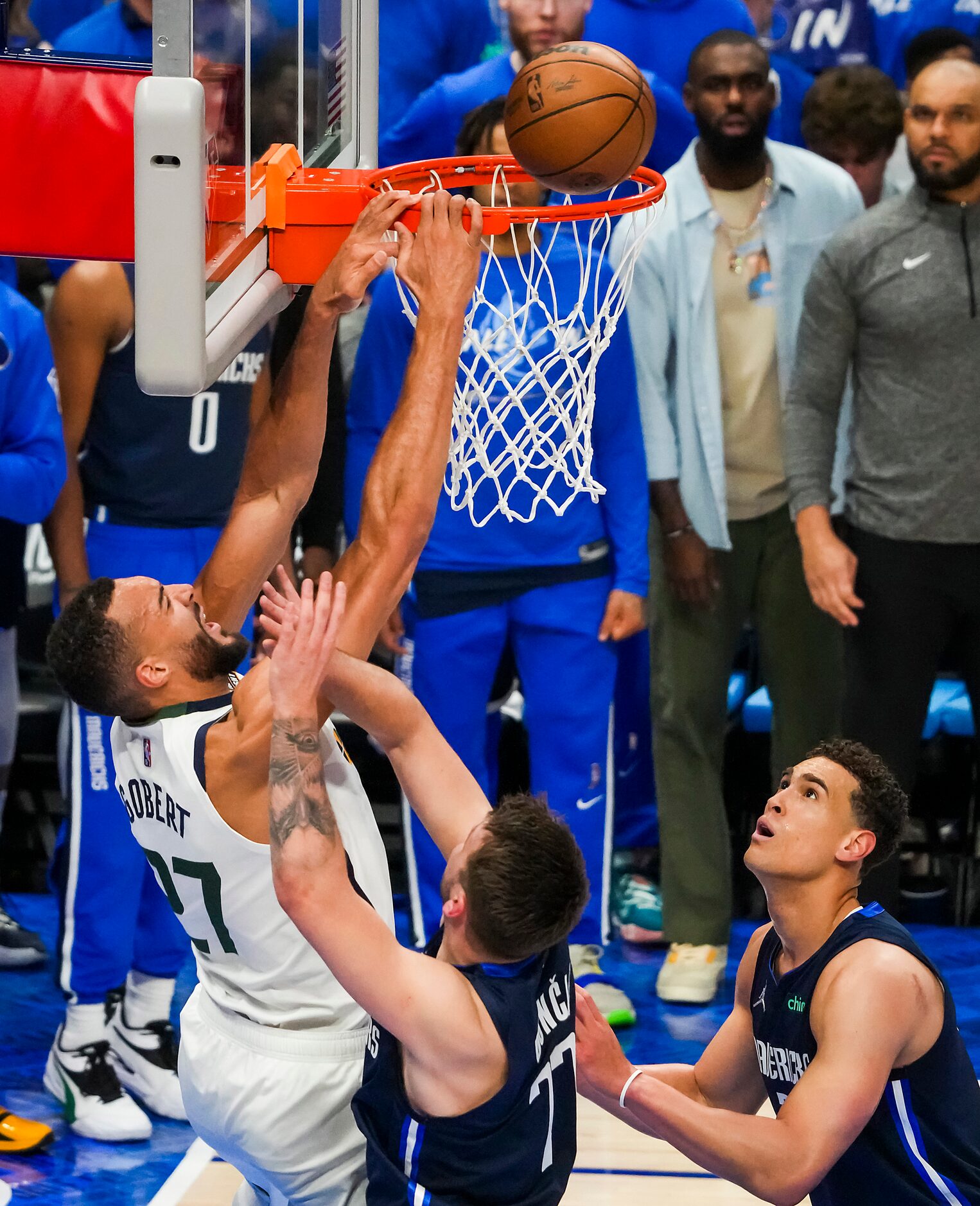 Utah Jazz center Rudy Gobert (27) misses a dunk as Dallas Mavericks guard Luka Doncic (77)...