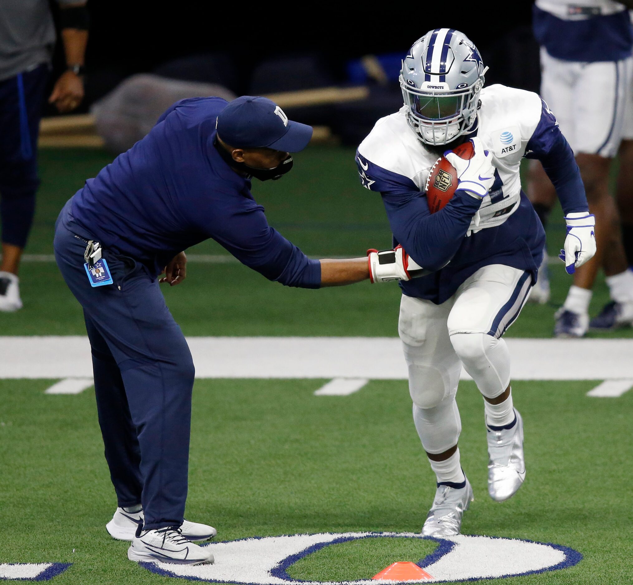 Dallas Cowboys running back Ezekiel Elliott (21) runs through a drill during training camp...