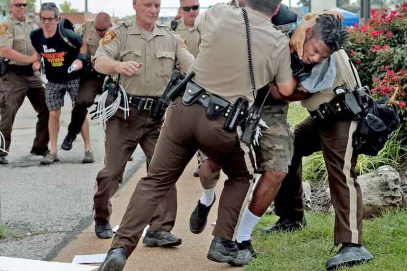 Police tackled a man in Ferguson, Mo., on Monday who had exchanged words with them after...