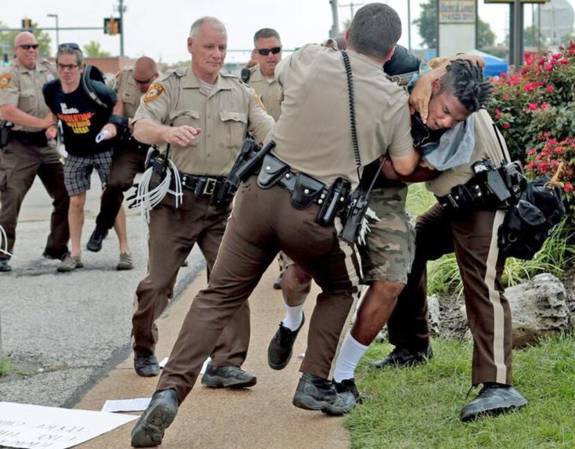Police tackled a man in Ferguson, Mo., on Monday who had exchanged words with them after...