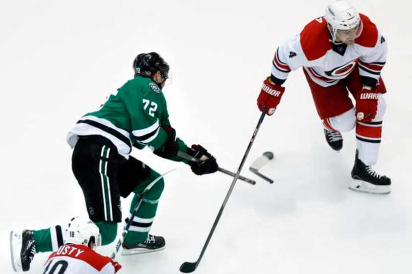 
Dallas Stars right wing Erik Cole (72) breaks his stick trying to make a shot past Carolina...