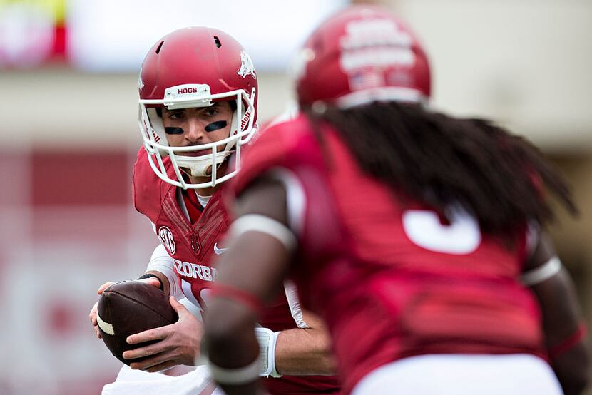 FAYETTEVILLE, AR - OCTOBER 24:  Brandon Allen #10 prepares to hand off the ball to Alex...