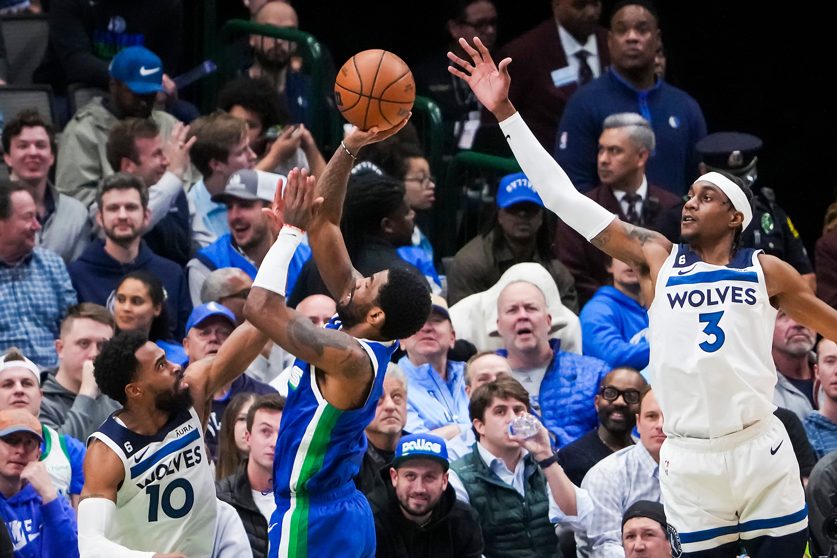 Dallas Mavericks guard Kyrie Irving (2) shoots past Minnesota Timberwolves guard Mike Conley...