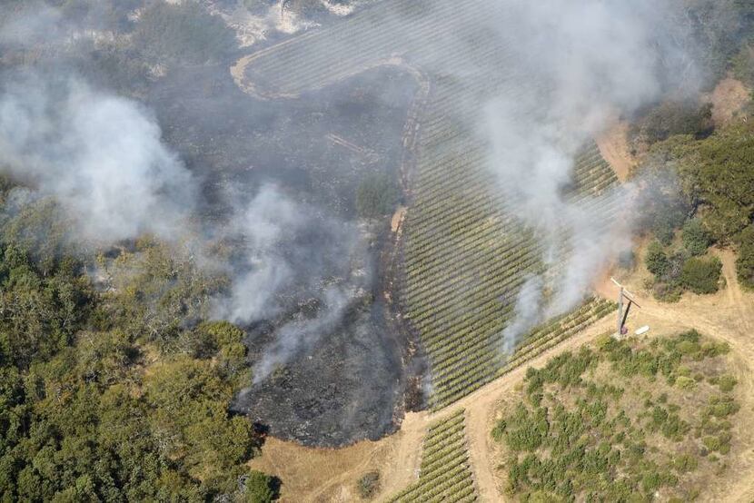 The rapidly spreading wildfires apprach Craig and Kathryn Hall's Walt Ranch vineyards, right.