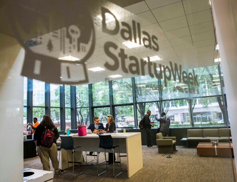 Participants work in a lounge area during Dallas Startup Week activities on Tuesday, April...