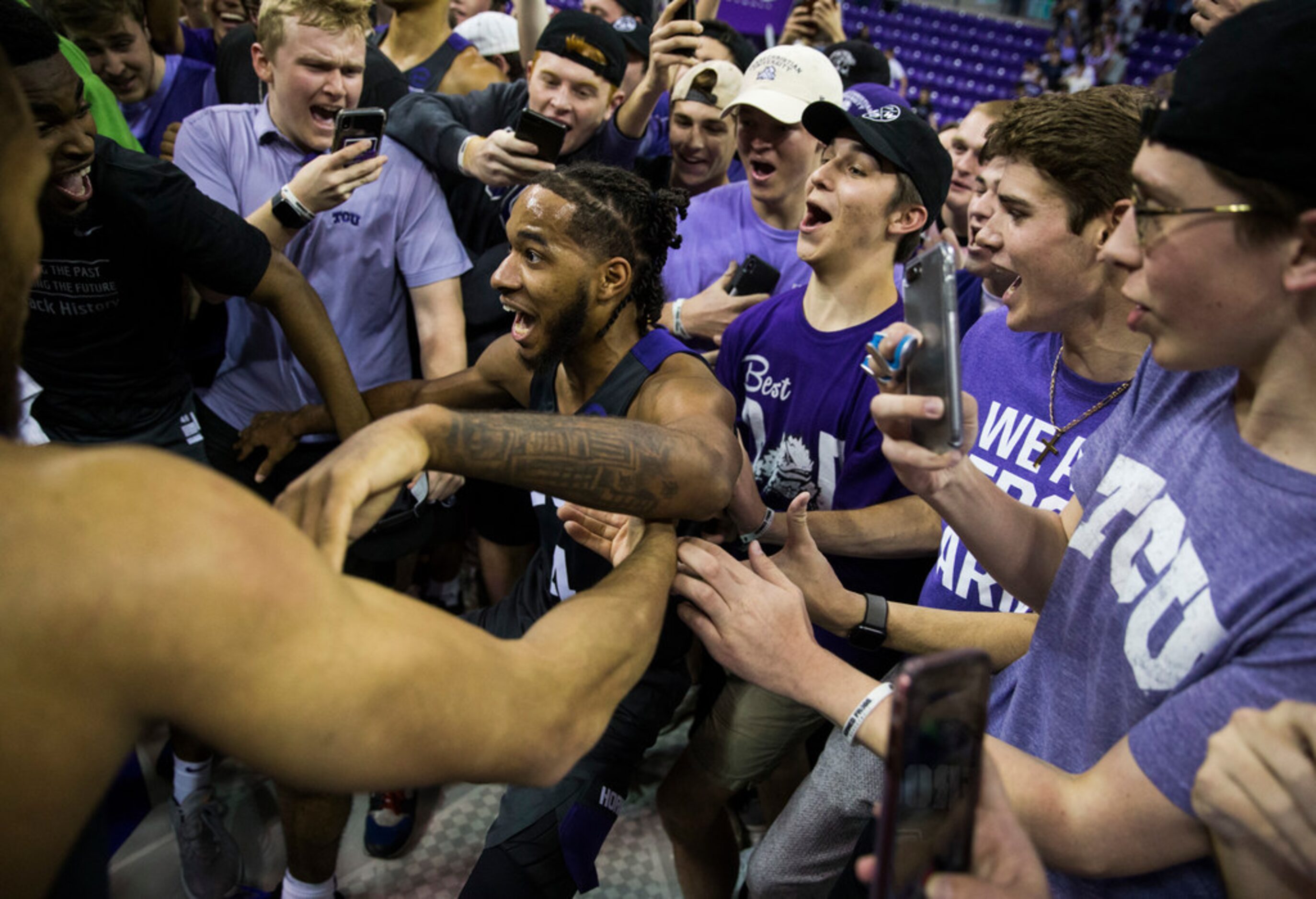 TCU Horned Frogs guard PJ Fuller (4) celebrates after fans rush the court because of a 75-72...