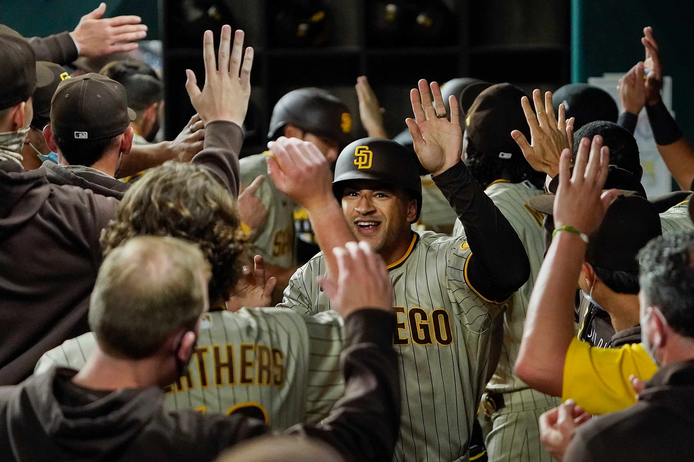 San Diego Padres center fielder Trent Grisham celebrates with teammates after hitting a...