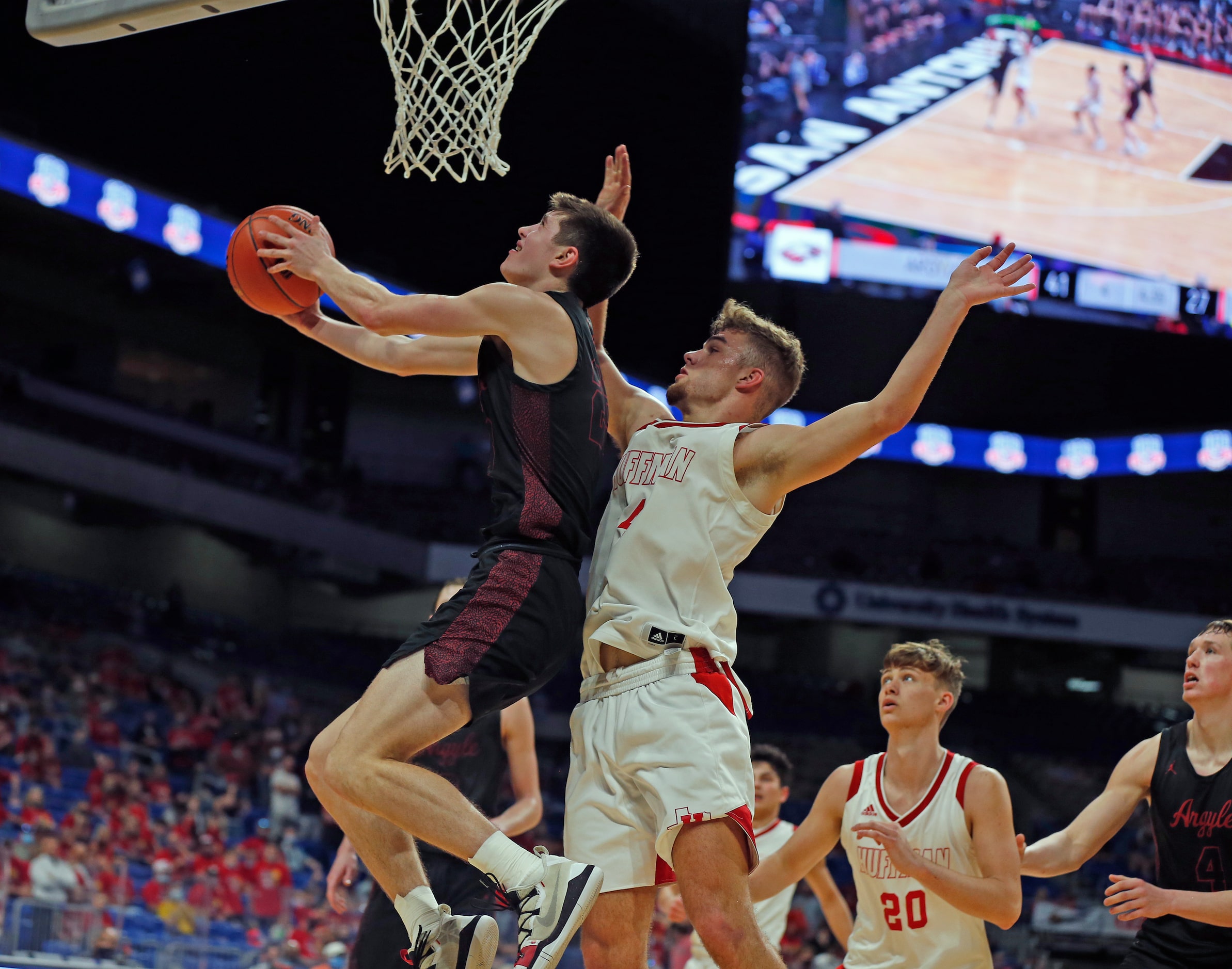 Argyle Eli Valentino #23 shoots  reverse layup on Huffman Hargrave Luke Thomas #4. UIL boys...