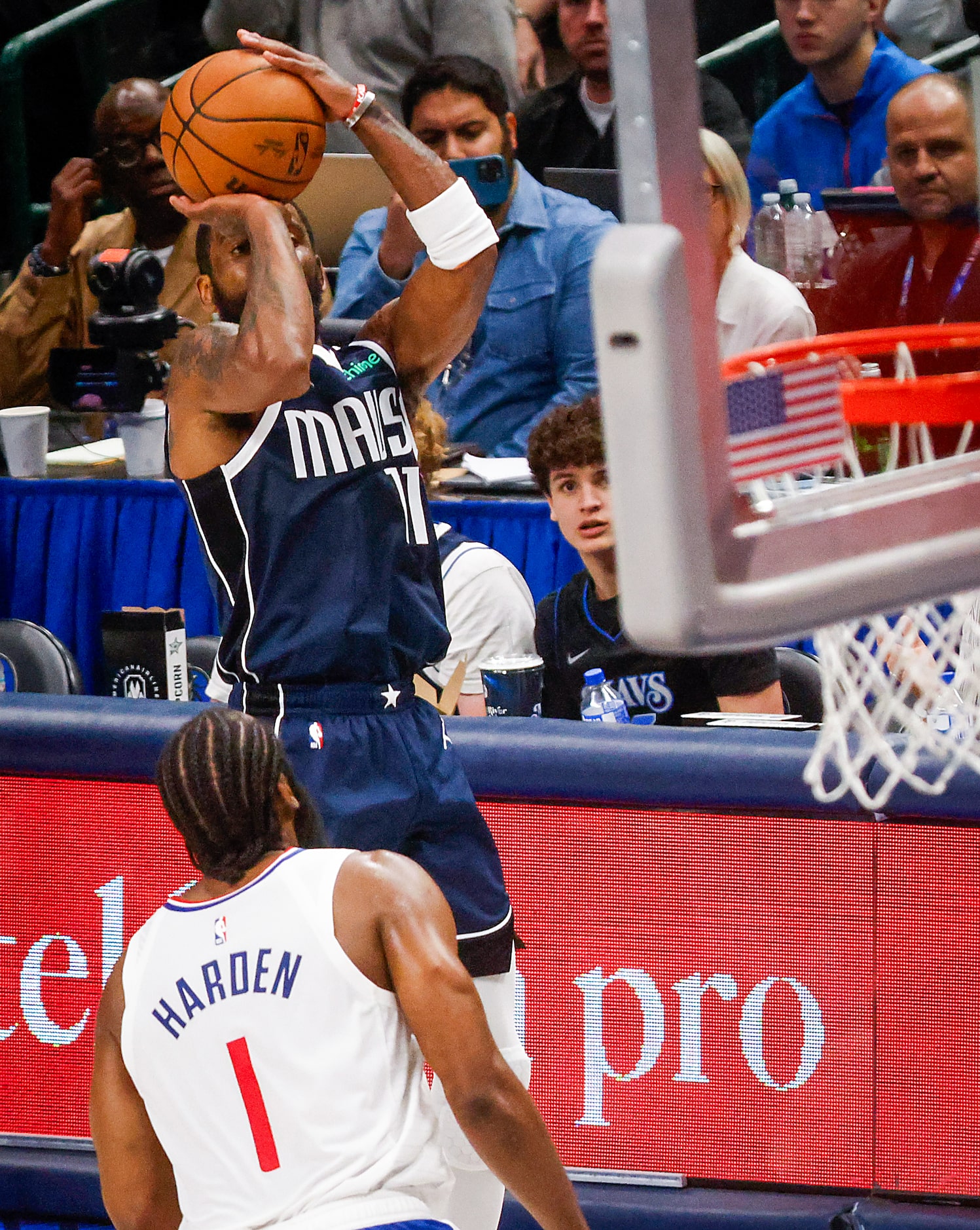 Dallas Mavericks guard Kyrie Irving shoots a three-pointer past LA Clippers guard James...