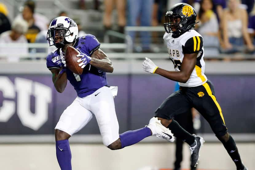 FILE - TCU receiver Jalen Reagor (1) reels in a long touchdown in front of Arkansas-Pine...