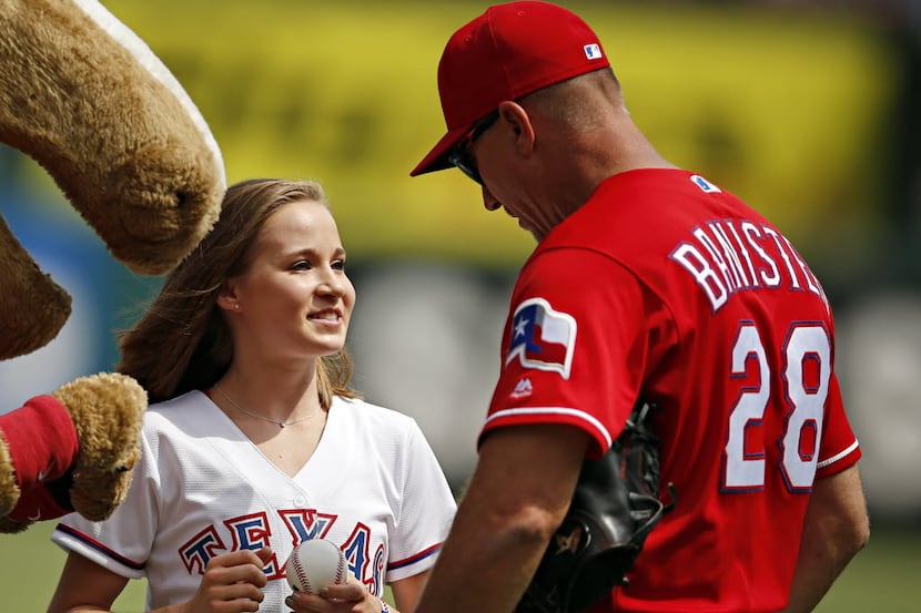 Olympic gold medalist Madison Kocian (center) smiles as she talks with Texas Rangers manager...