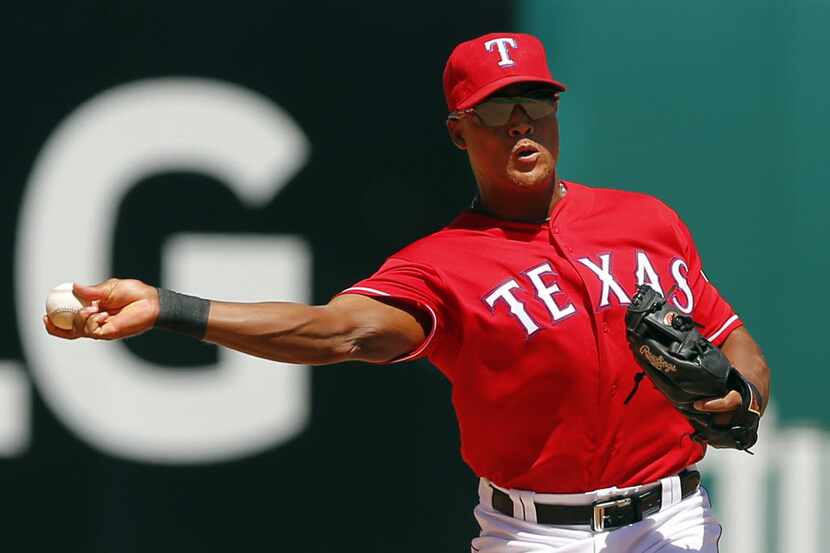 Texas Rangers third baseman Adrian Beltre (29) throws to first for a Seattle Mariners out at...