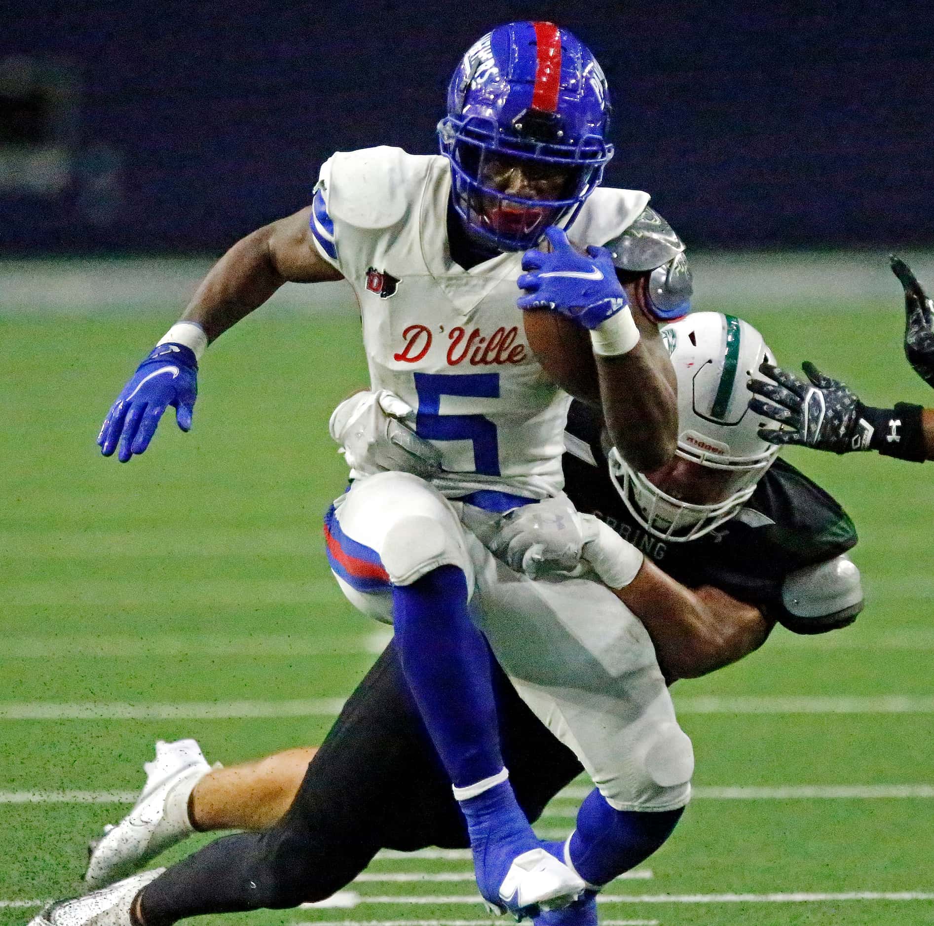 Duncanville High School running back Malachi Medlock (5) is brought down by Spring High...