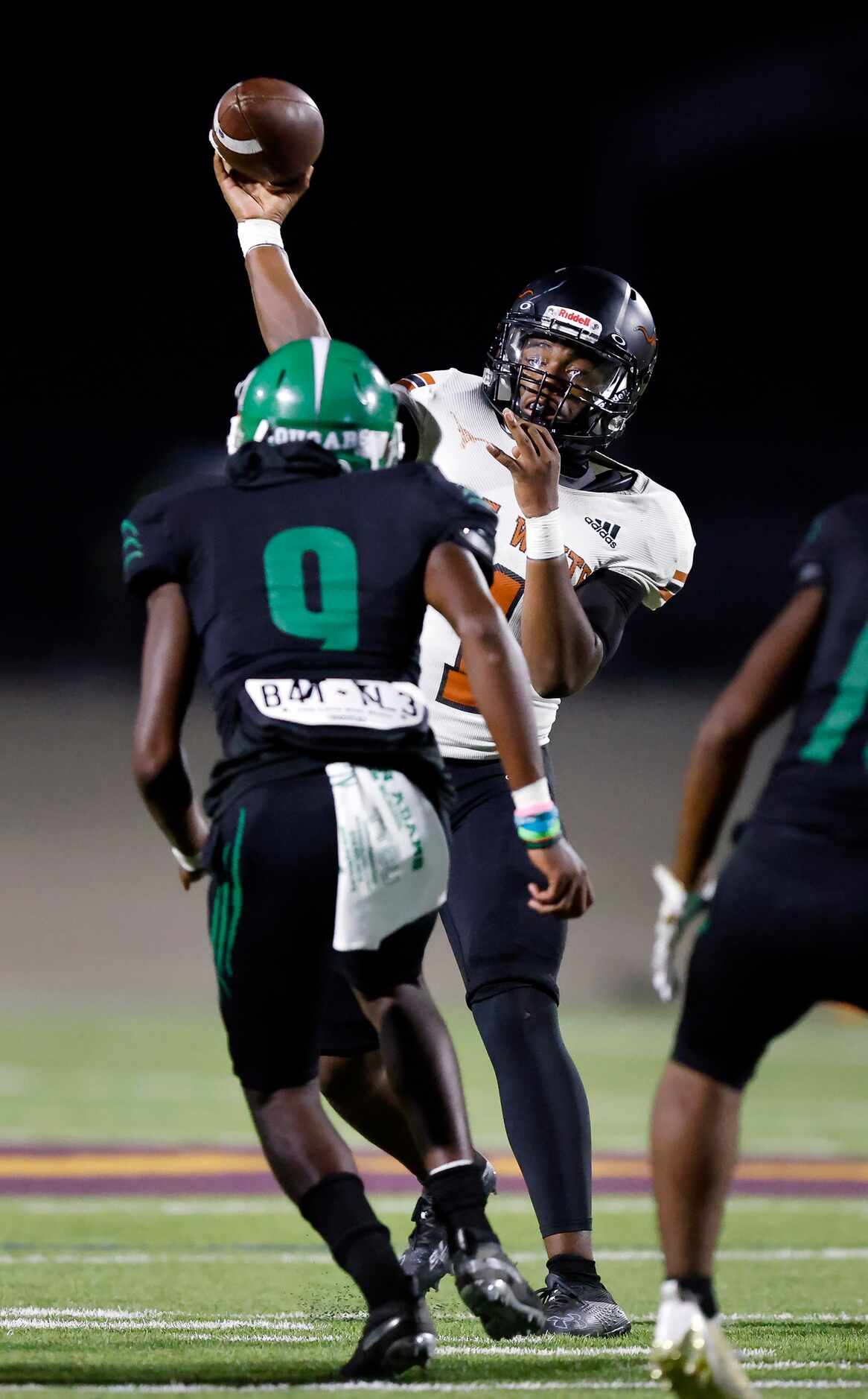 W.T. White quarterback Jaydyn Sisk (1) throws a touchdown pass over Bryan Adams defensive...