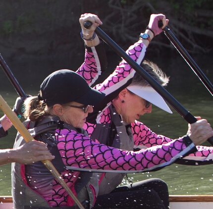 Jane Ellen Shilling (left) and Donna Coker work in unison as they power through rowing...